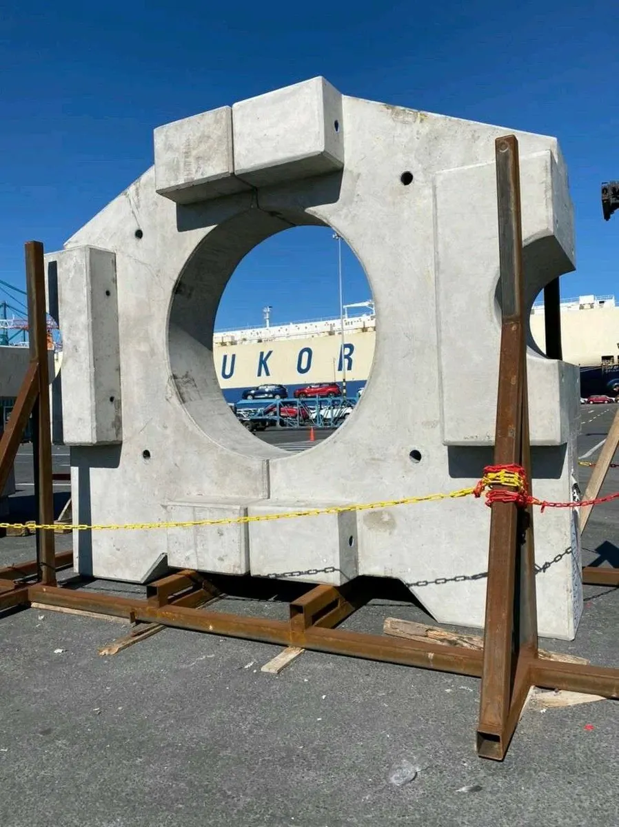 Lastre de hormigón con abertura circular para tubería, en patio de acopio